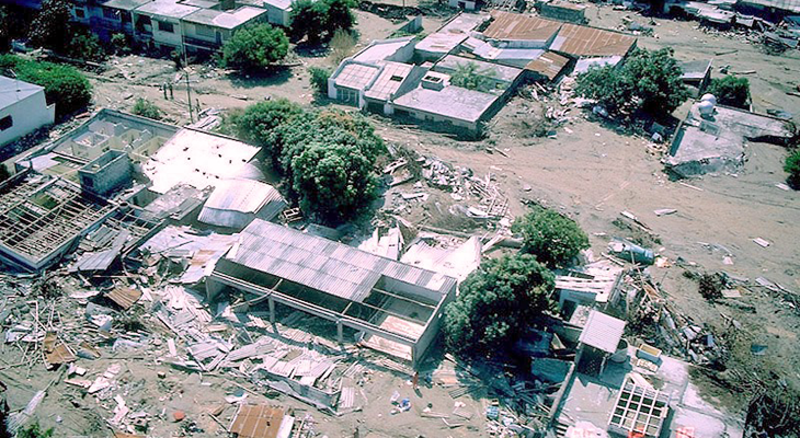 an aerial photo of the town of Armero in Colombia showing the only buildings left standing after a lahar.