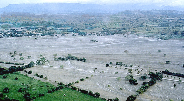 an aerial photo of where the Columbian town of Armero used to stand, covered in mud and ash