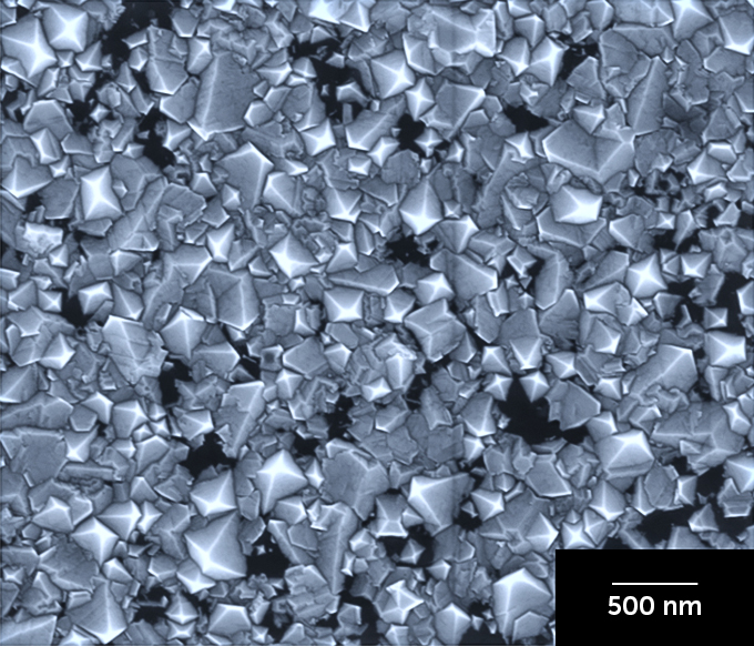 A sheet of diamonds made in a laboratory with a scale bar reading "500 nm."
