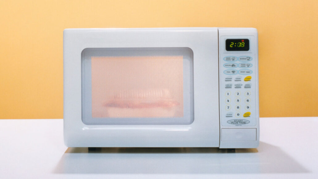 a photo of a microwave oven against an orange backdrop