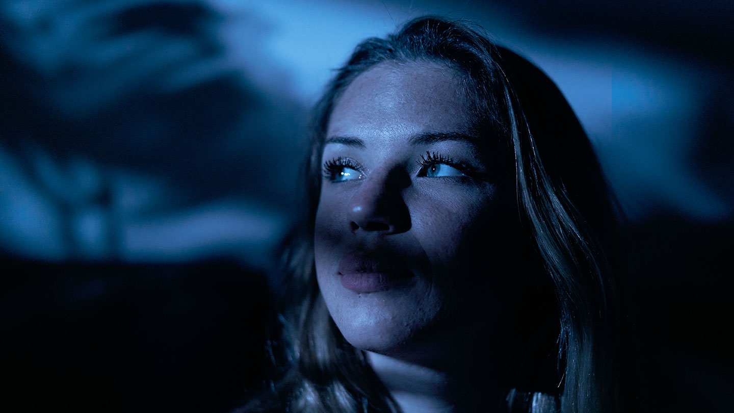 a shadowed image of a young woman looking to the side