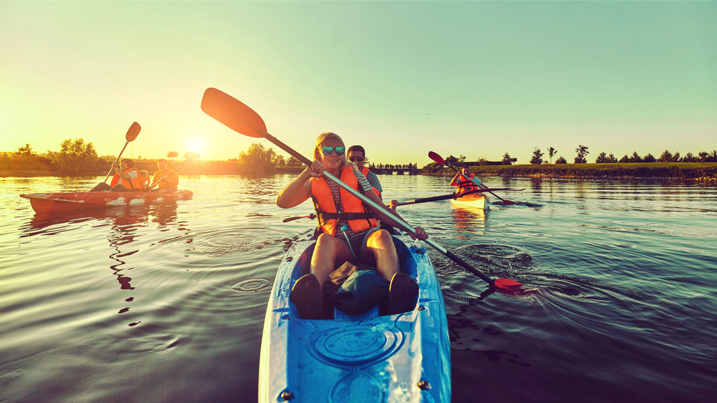 several young people on kayaks 