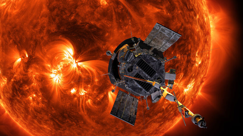 An illustration shows the Parker Solar Probe approaching the orange sun. The metallic craft sports small instruments, two reflective sails and a long rod jutting out of one end. 