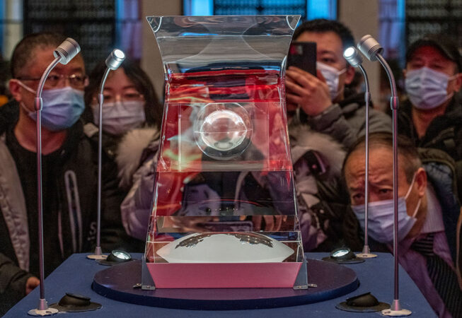 a photo form an event in Beijing where people viewed samples of lunar rock from the dark side of the moon