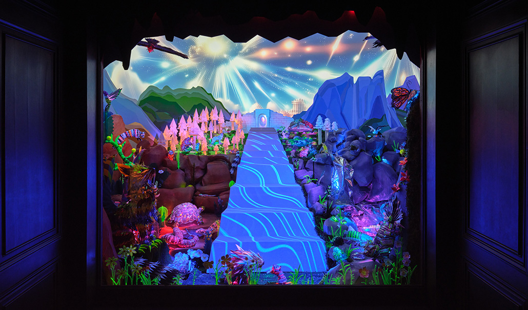 Brightly colored materials adorn this whimsical diorama of a flowing river surrounded by flora and fauna under a starry sky at the Natural History Museum of Los Angeles.