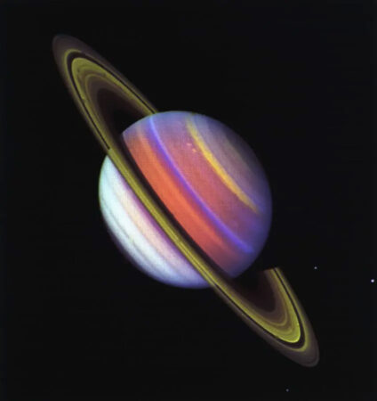 a technicolor (orange, purple, yellow) composite image of Saturn