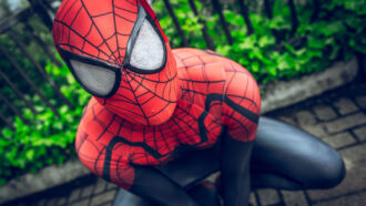 A close-up of Spider-Man crouched on a building