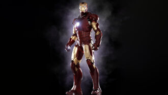 Iron Man stands against a black background wearing his metallic robot armour. The metal plates are red and gold.