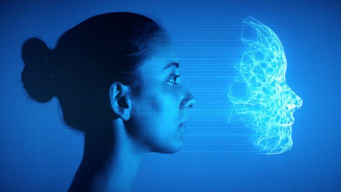 a digitally enhanced portrait showing a woman looking to the right, in profile, a vector mask of light floats a few inches to the right of her face, the background is blue and full of 0s and 1s